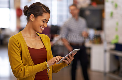 Buy stock photo Cropped shot of a young businesswoman using her digital tablet in the office