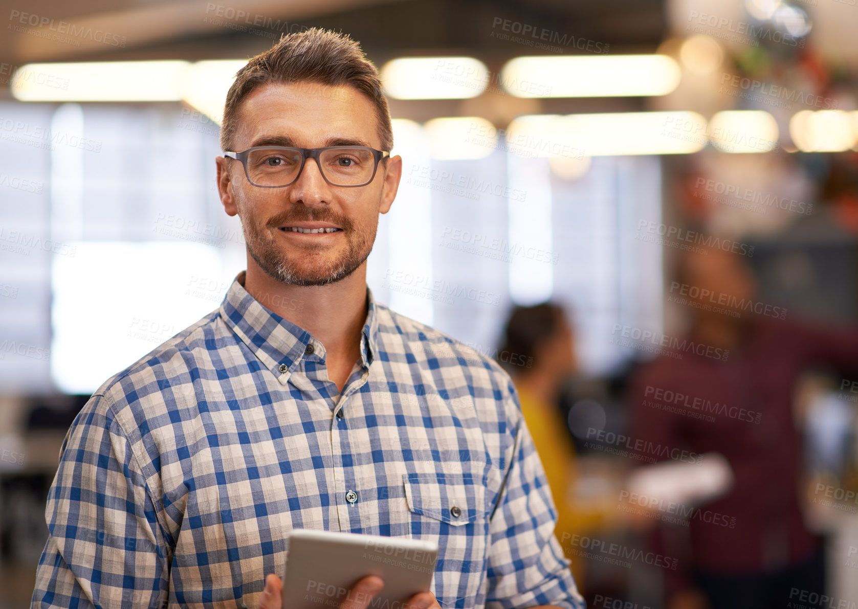 Buy stock photo Cropped portrait of a mature businessman standing with a digital tablet in the office