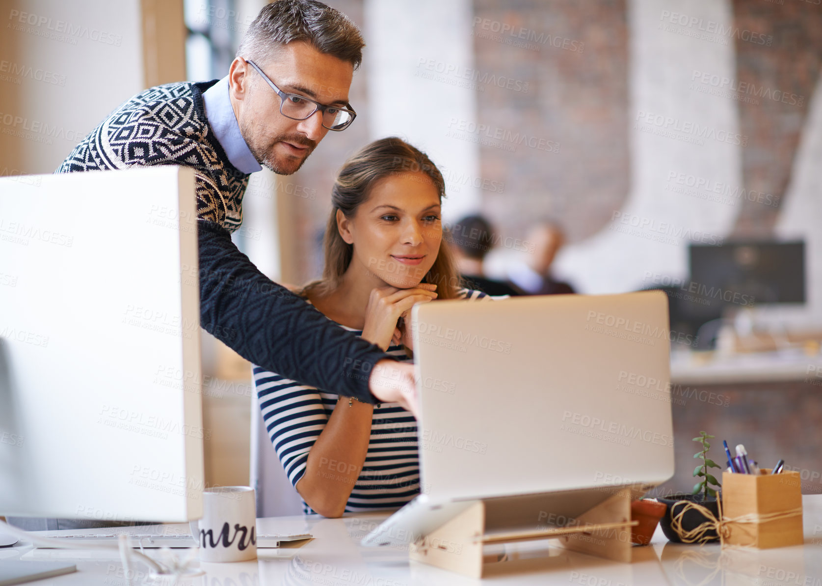 Buy stock photo Shot of two designers working together at a computer