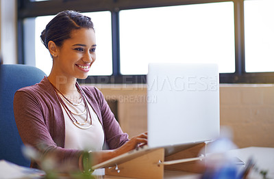 Buy stock photo Shot of a young businesswoman working on her laptop in the office