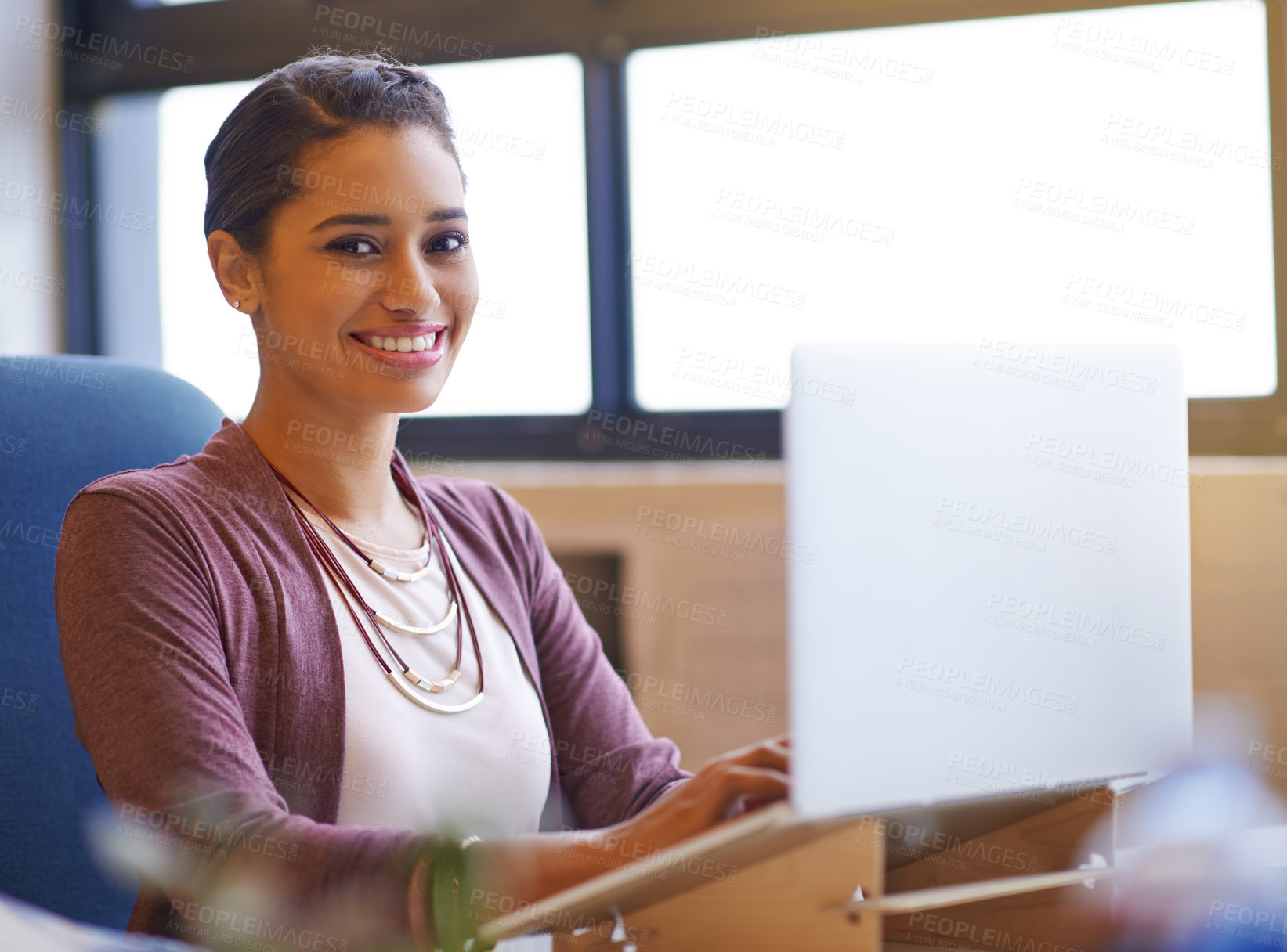 Buy stock photo Shot of a young businesswoman working on her laptop in the office