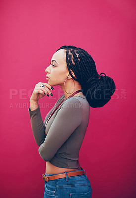 Buy stock photo Profile shot  an attractive young woman posing against a pink background