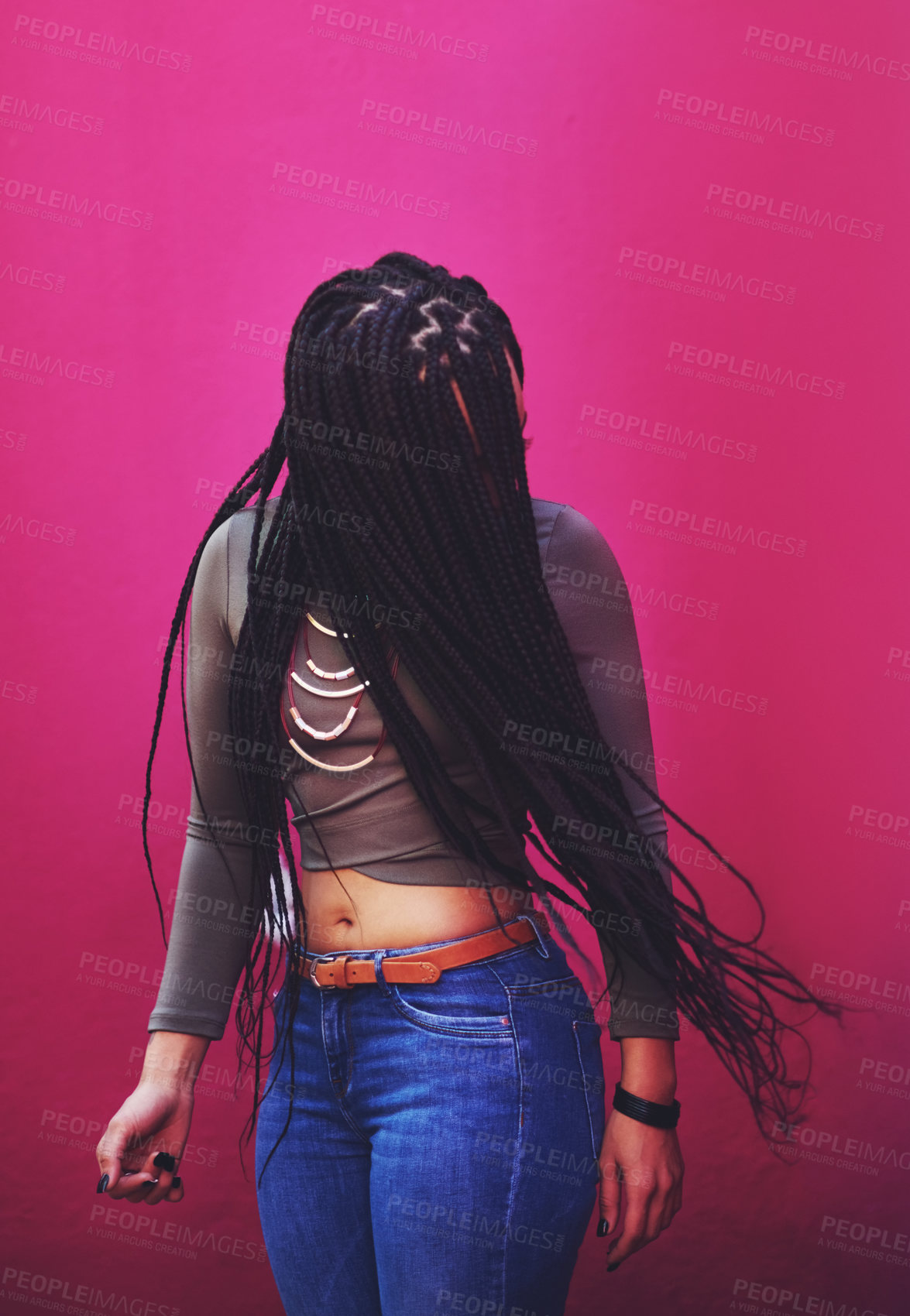 Buy stock photo Shot of a young woman with braids posing against a pink background
