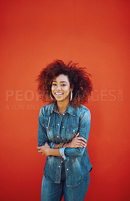 Buy stock photo Portrait of an attractive young woman posing against a red background
