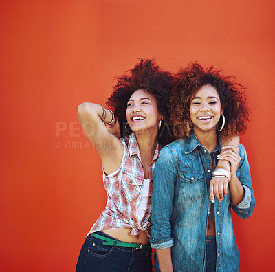 Buy stock photo Shot of two young friends posing against a red background