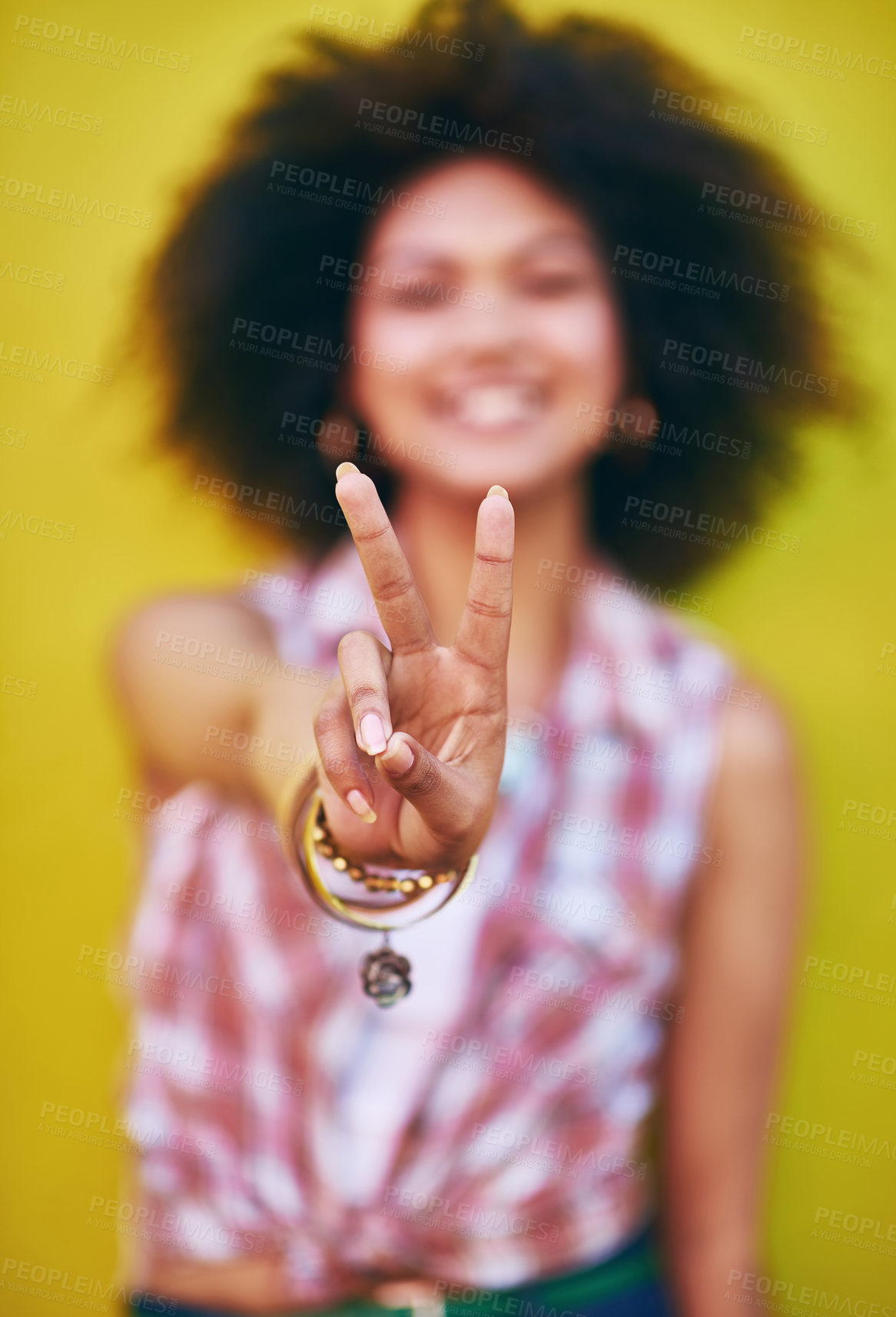 Buy stock photo Closeup shot of a young woman showing the peace sign