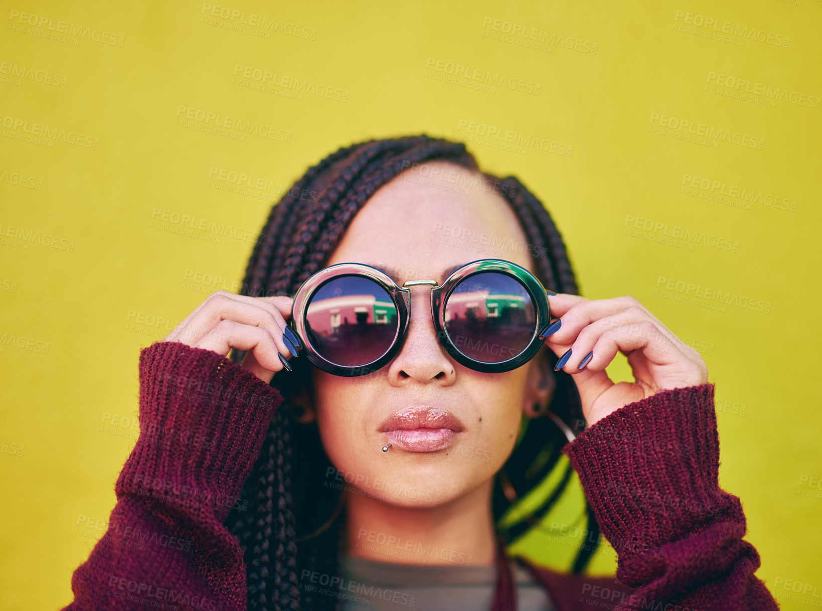 Buy stock photo Shot of a young woman wearing sunglasses against a green background