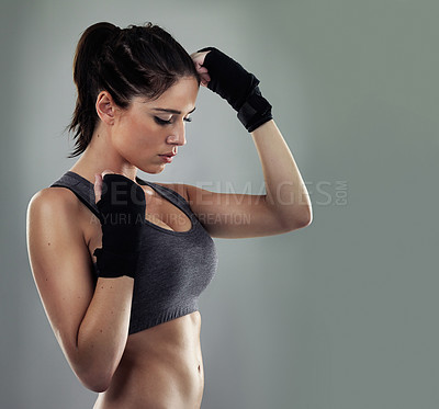 Buy stock photo Studio shot of a sporty young woman against a gray background