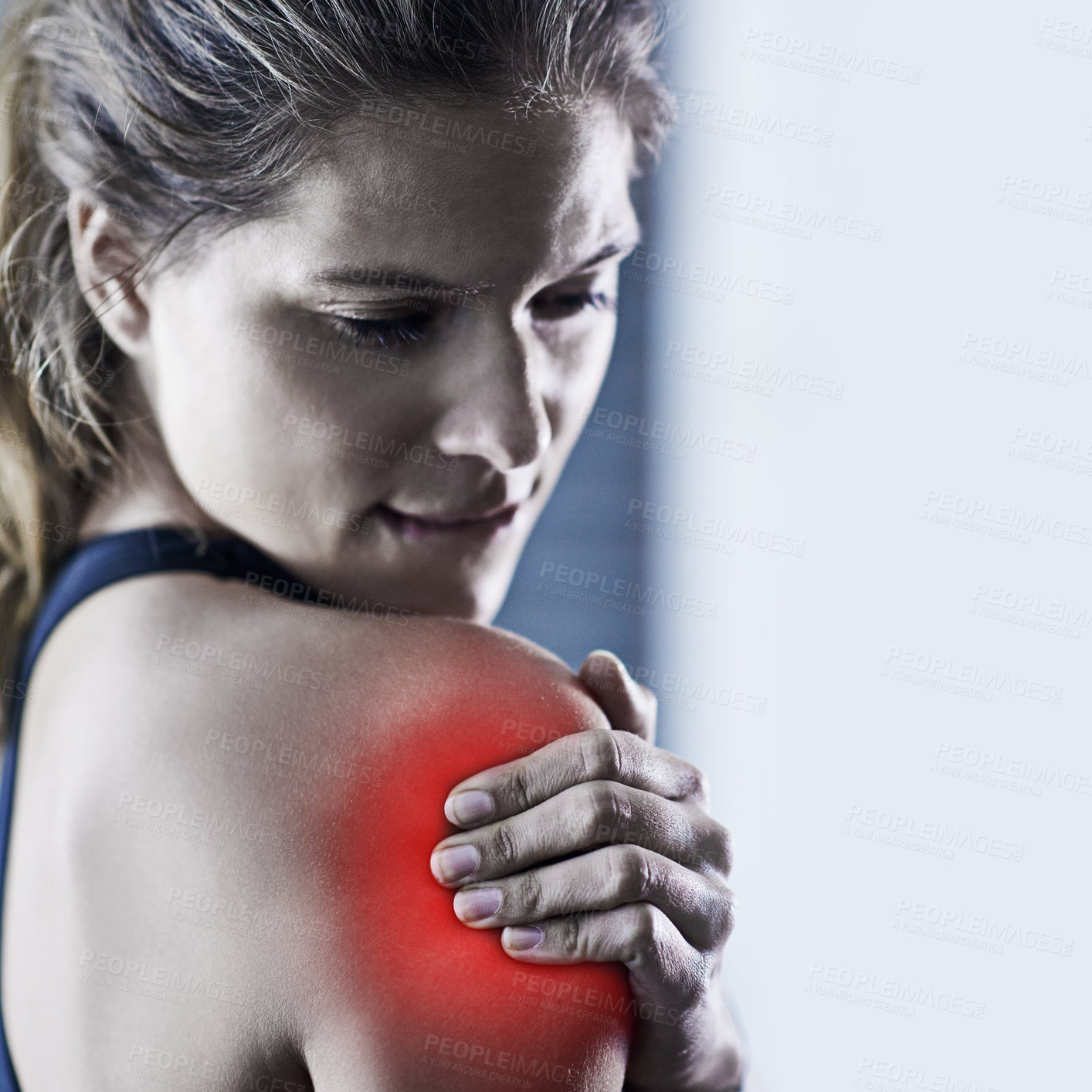 Buy stock photo Shot of a young woman holding her injured shoulder that's highlighted in red