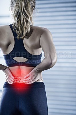 Buy stock photo Rearview shot of a young woman holding her injured back that's highlighted in red