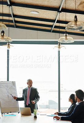 Buy stock photo Shot of a group of executives having a meeting in a boardroom