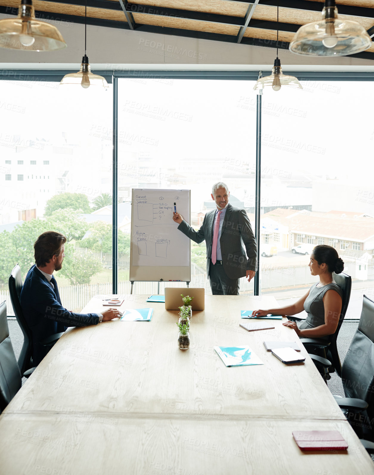 Buy stock photo Shot of a group of executives having a meeting in a boardroom