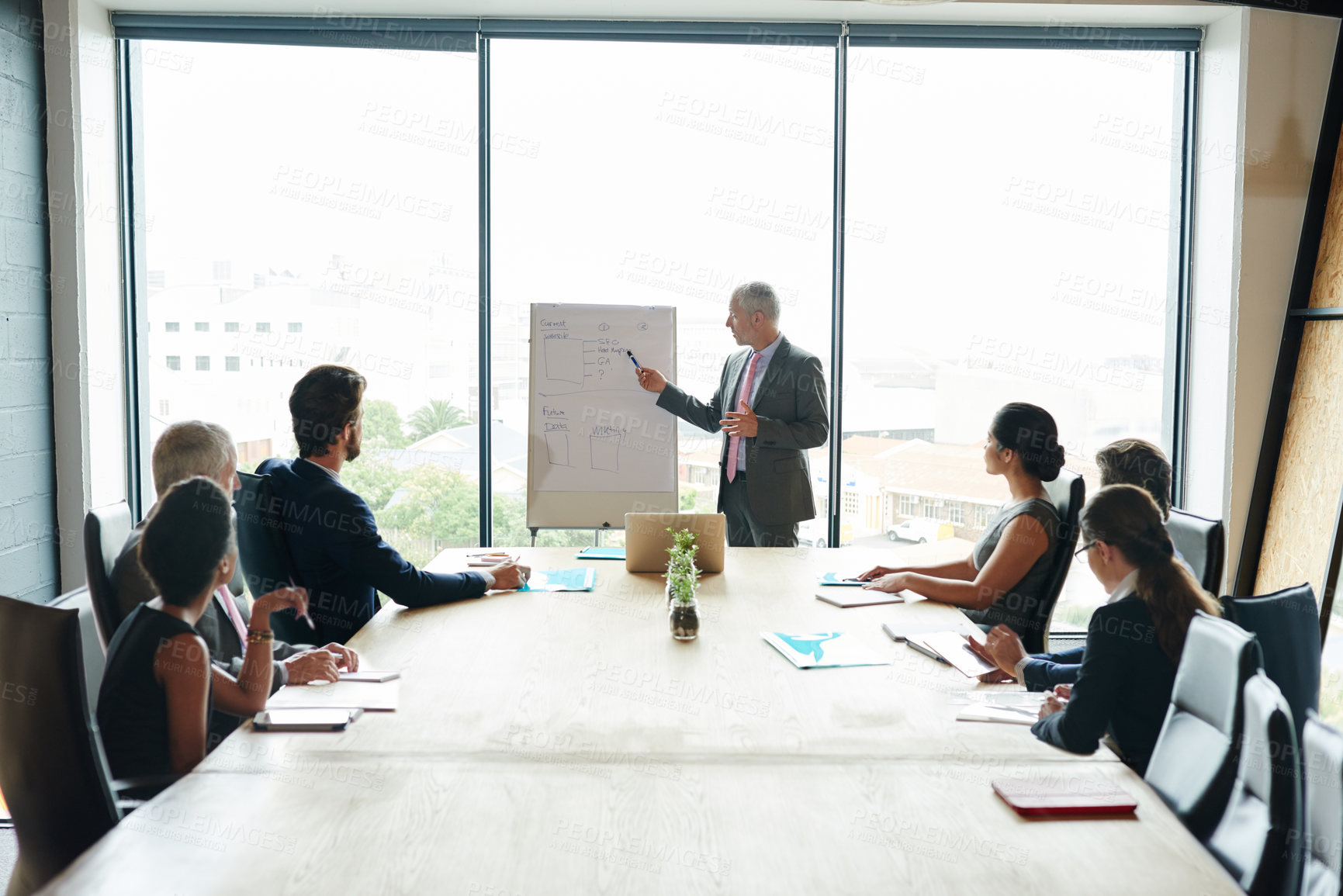 Buy stock photo Shot of a group of executives having a meeting in a boardroom