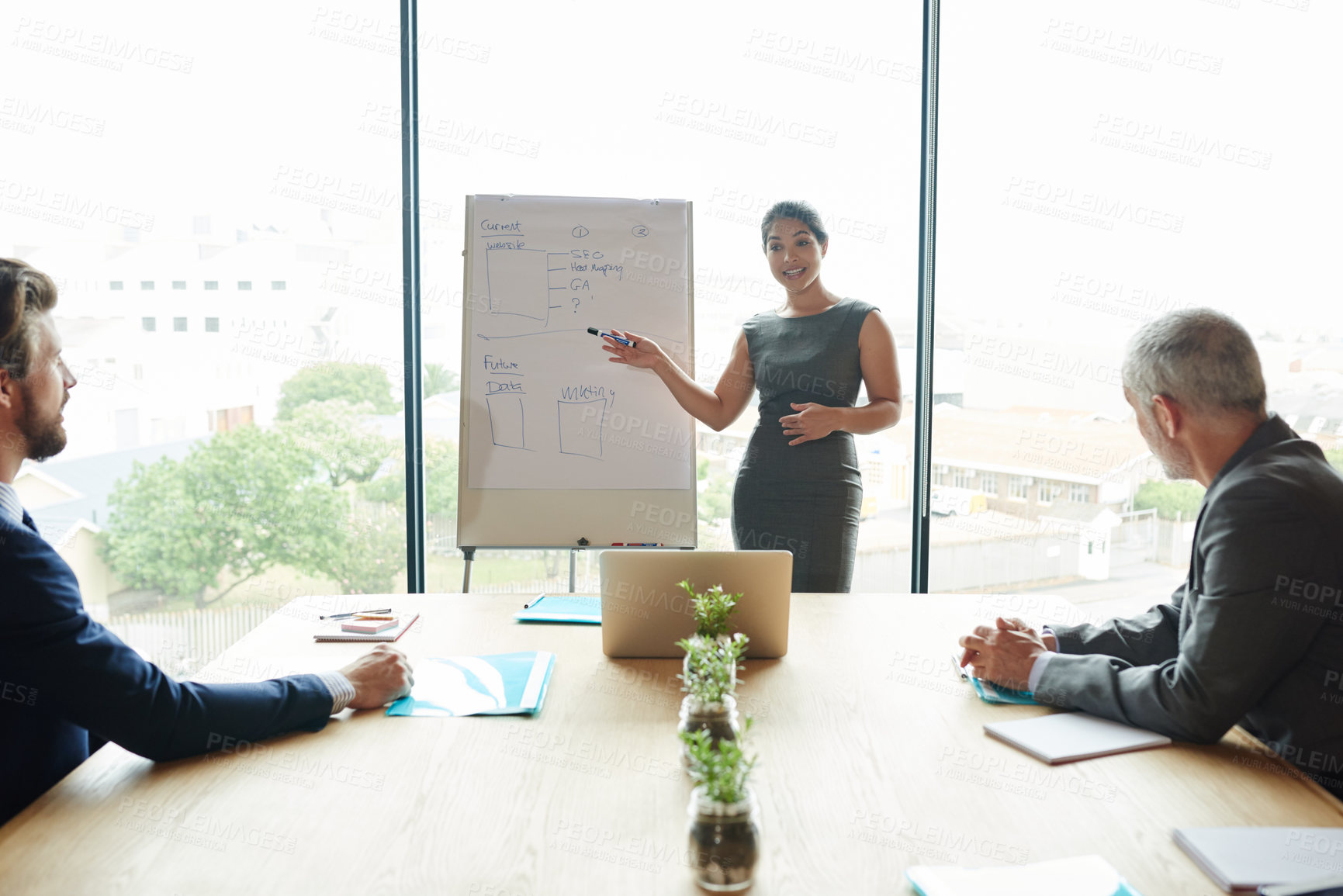 Buy stock photo Shot of a group of executives having a meeting in a boardroom