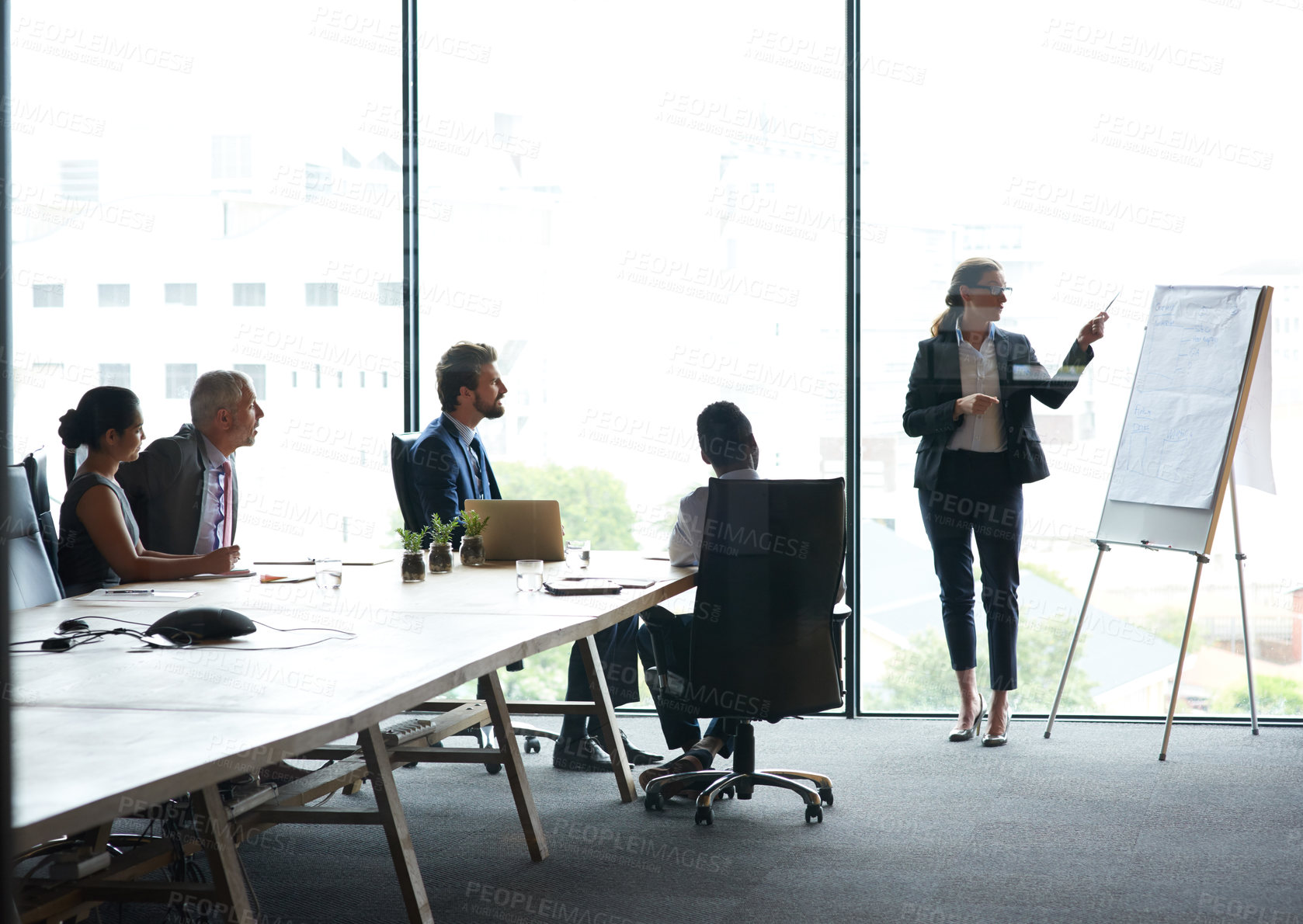 Buy stock photo Shot of a group of executives having a meeting in a boardroom