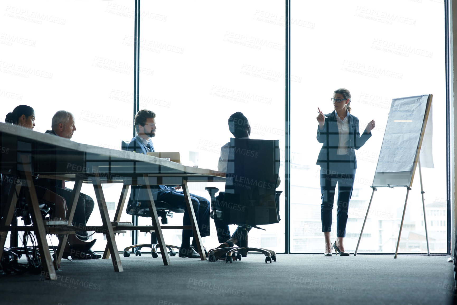 Buy stock photo Shot of a group of executives having a meeting in a boardroom