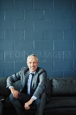 Buy stock photo Portrait of a successful businessman sitting on a sofa