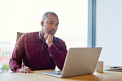 Buy stock photo Shot of a businessman working on his laptop at his desk