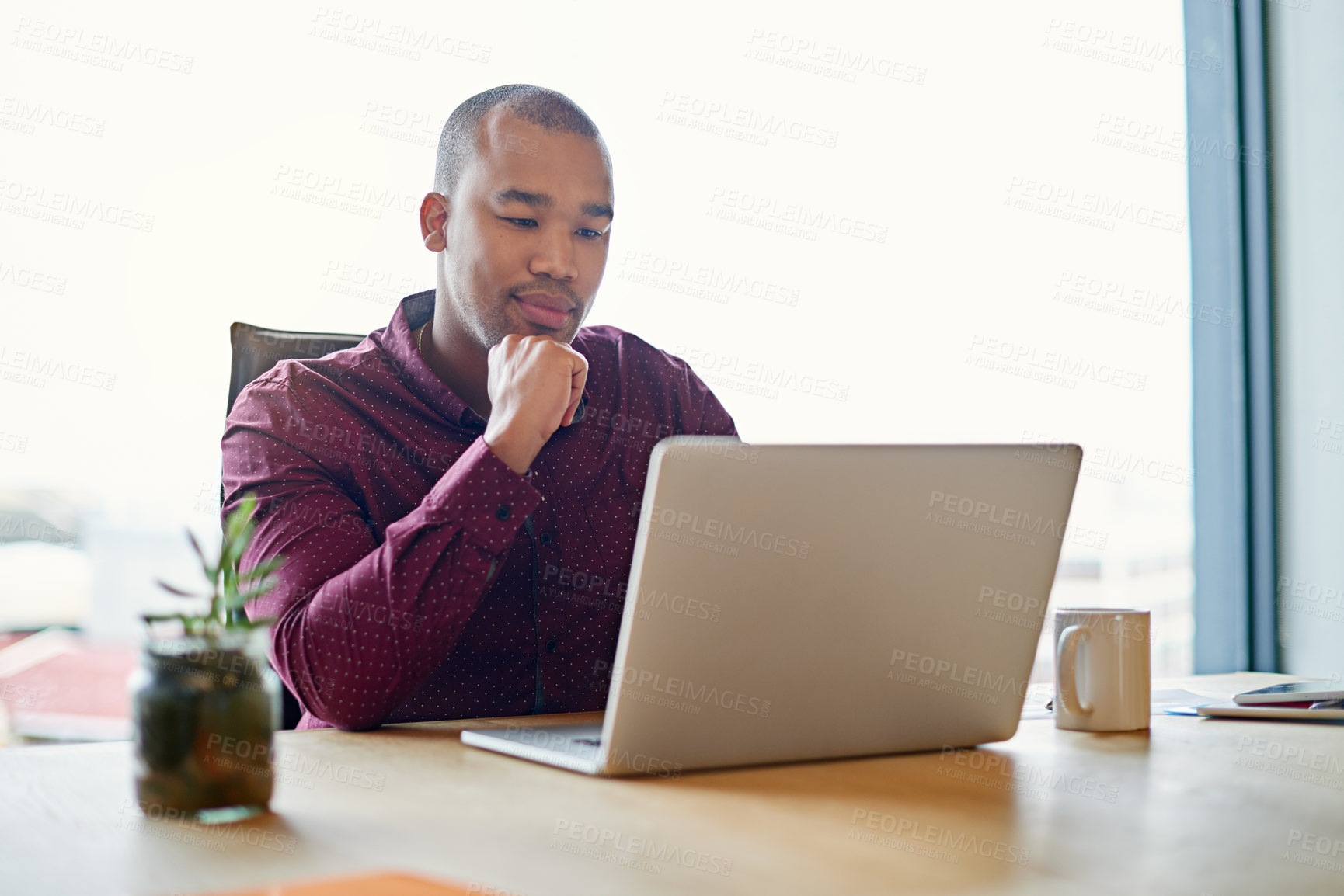 Buy stock photo Shot of a businessman working on his laptop at his desk