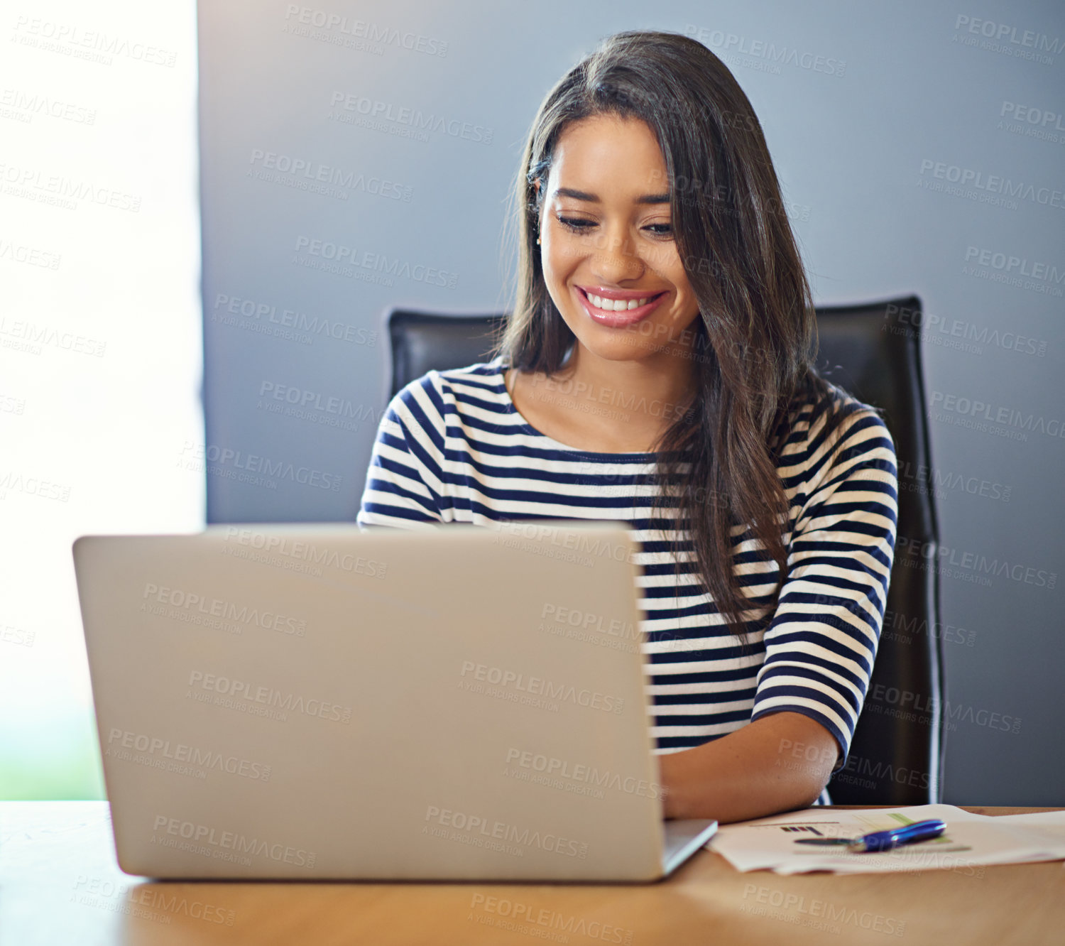 Buy stock photo Shot of a businesswoman working on her laptop in the office