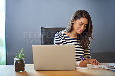 Buy stock photo Shot of a businesswoman working on her laptop in the office