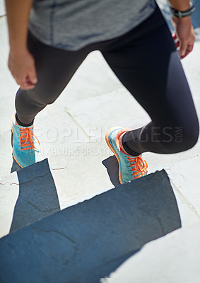 Buy stock photo Cropped shot of a sporty young woman standing on steps outside