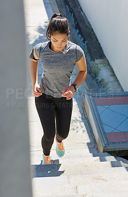 Buy stock photo Woman, running and stairs with earphones for fitness, workout or cardio exercise in city. Female person, athlete or runner on steps with headphones for training or listening to music in an urban town