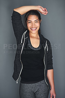 Buy stock photo Portrait of a fit young woman in sports clothing posing against a gray background