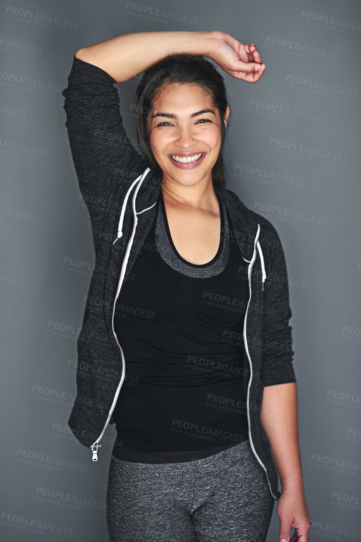 Buy stock photo Portrait of a fit young woman in sports clothing posing against a gray background