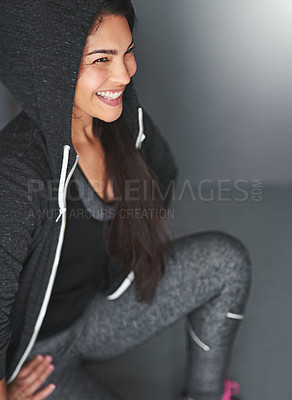 Buy stock photo Smile, squat and woman in gym for fitness, training and body wellness goals with hoodie in studio. Happy, health and girl with exercise for growth, development and sportswear on grey background