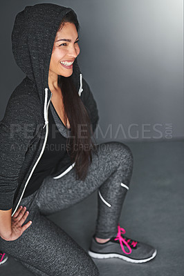 Buy stock photo Shot of a fit young woman exercising indoors