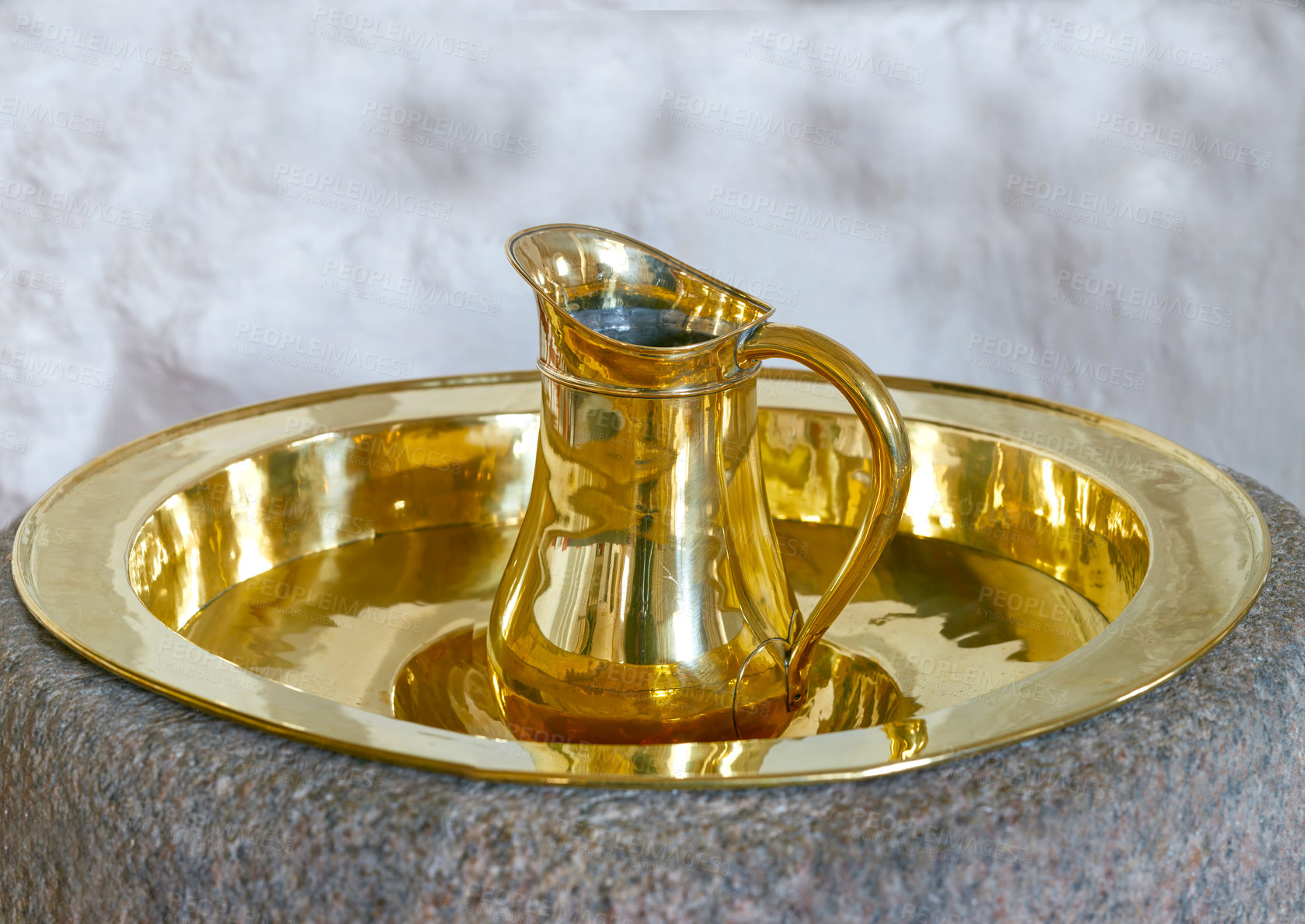 Buy stock photo Closeup of a gold baptism jug. Traditional water pouring cup used as a sacred tool for christening or naming ceremony at church. A holy baptismal font or religious object used in the Christian faith