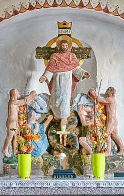 Buy stock photo Closeup of an alter at a historic church with Jesus on a cross. 12th century old public Danish National church in Faarup Denmark. A nave inside a house of prayer where congregation gather for worship