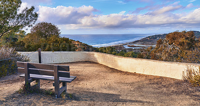 Buy stock photo Park, outdoor bench and landscape of beach for travel location, holiday destination and scenery of ocean. Nature, horizon and blue sky for adventure, hiking and sightseeing view of sea in California