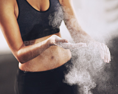 Buy stock photo Cropped shot of a woman coating her hands with sports chalk before a workout