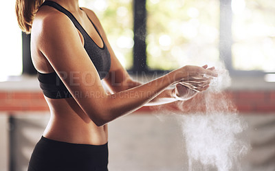 Buy stock photo Cropped shot of a woman coating her hands with sports chalk before a workout