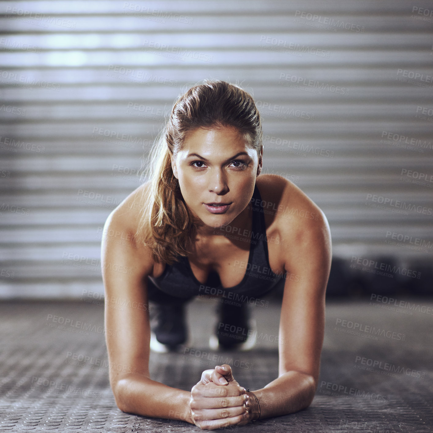 Buy stock photo Shot of a young woman doing a plank exercise at the gym