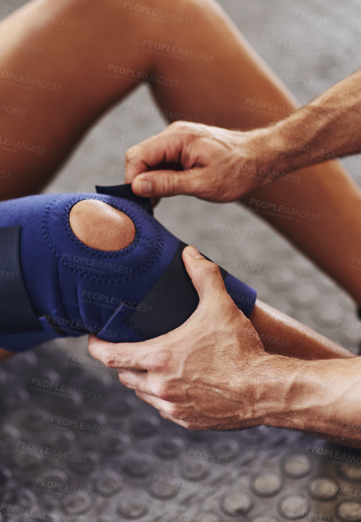 Buy stock photo Shot of a sportswoman being helped with a knee injury