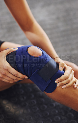 Buy stock photo Shot of a sportswoman wearing a knee brace