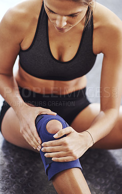 Buy stock photo Shot of a sportswoman wearing a knee brace