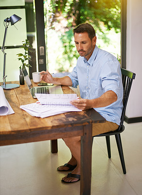 Buy stock photo Shot of a young man working from home