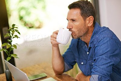 Buy stock photo Shot of a young man working on a laptop at home
