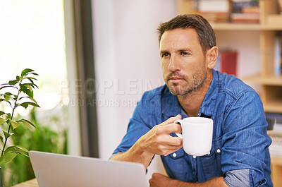 Buy stock photo A young woman drinking coffee while working from home
