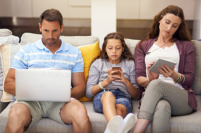 Buy stock photo Technology, family and home with screen addiction, anti social and laptop in living room. Apartment, parents and mother with father, daughter on couch and cellphone with internet, tablet and overuse