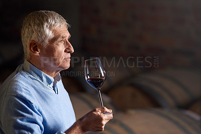 Buy stock photo Cropped shot of a senior man wine tasting in a cellar