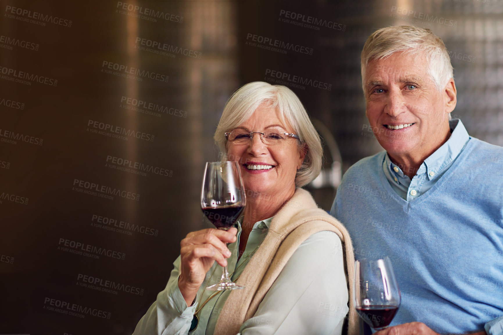 Buy stock photo Cropped portrait of an affectionate senior couple wine tasting in a cellar