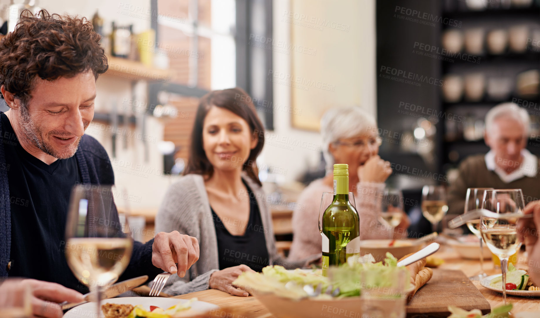 Buy stock photo Smile, eating and family at dinner in dining room for party, celebration or event at modern home. Happy, bonding and group of people enjoying meal, supper or lunch together with wine at house.