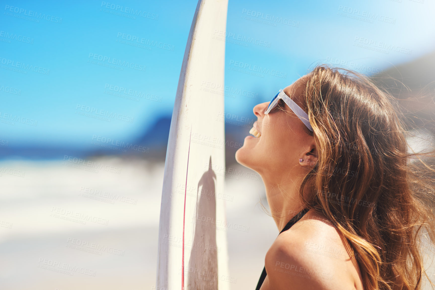 Buy stock photo Shot of a young surfer at the beach