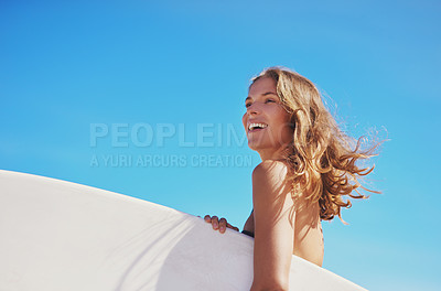 Buy stock photo Girl, laughing and board for surfing in outdoor, workout and blue sky for water sports competition. Female person, mockup space and travel to ocean for waves, calm and athlete for exercise in nature