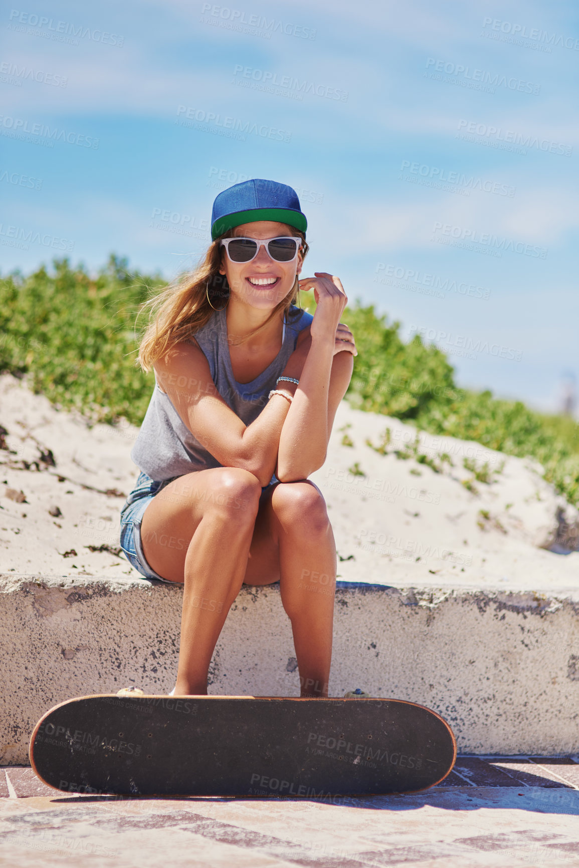 Buy stock photo Shot of a young woman at the beach with her skateboard